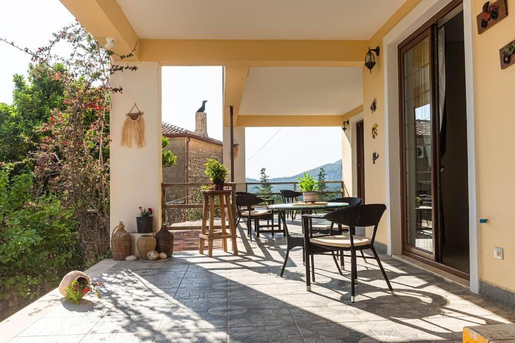 a patio with chairs and tables on a house at Color Villa - South Paradise 2 in Himare