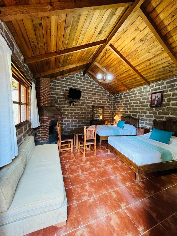 Postel nebo postele na pokoji v ubytování Cabañas Los Cactus