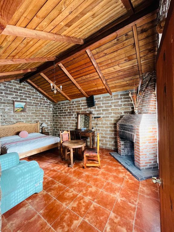 Postel nebo postele na pokoji v ubytování Cabañas Los Cactus