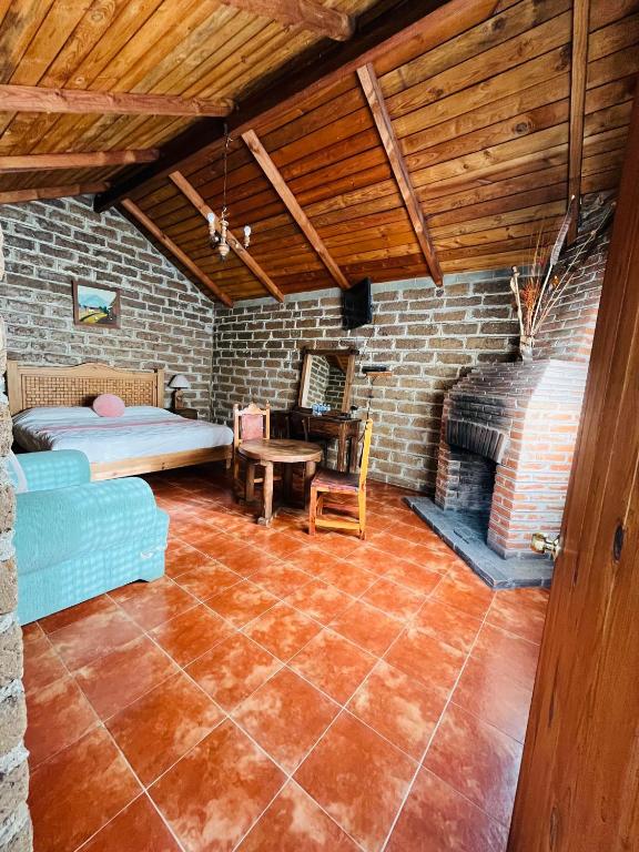 Postel nebo postele na pokoji v ubytování Cabañas Los Cactus