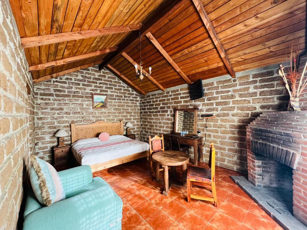 Postel nebo postele na pokoji v ubytování Cabañas Los Cactus
