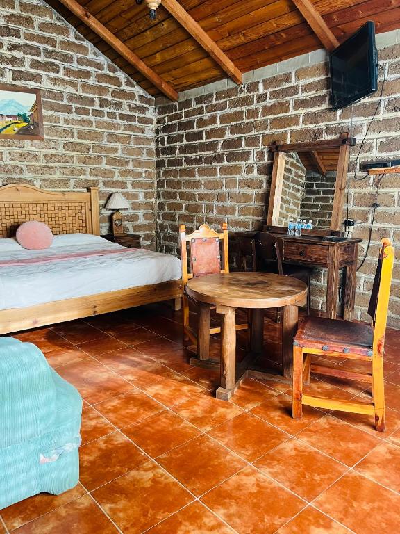 Postel nebo postele na pokoji v ubytování Cabañas Los Cactus