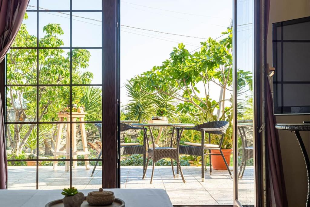 a room with a table and a large window at Color Villa - South Paradise 3 in Himare