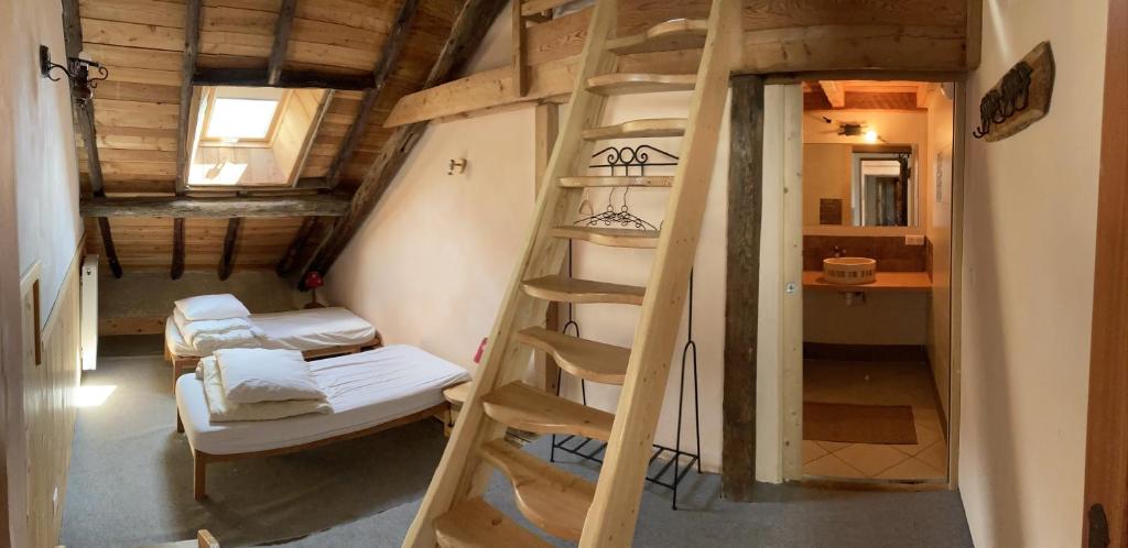 Postel nebo postele na pokoji v ubytování Gîte Le Moulin papillon