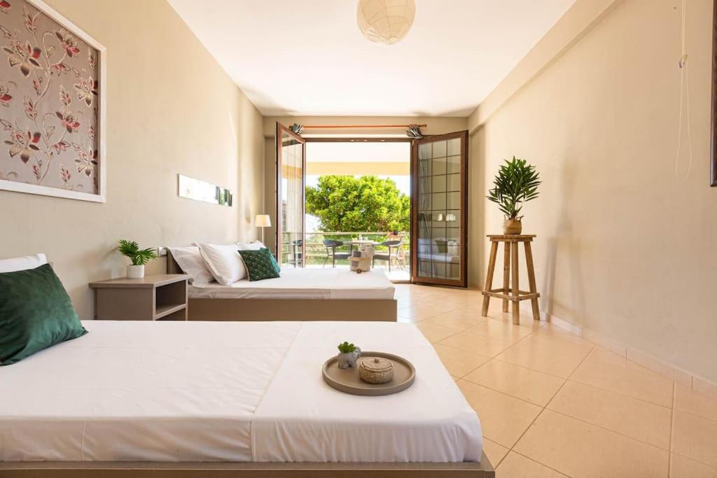a hotel room with two beds and a balcony at Color Villa - South Paradise 7 in Himare