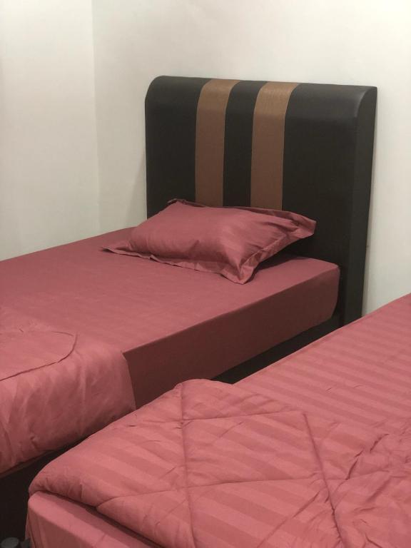 Postel nebo postele na pokoji v ubytování Homestay Siti Klang