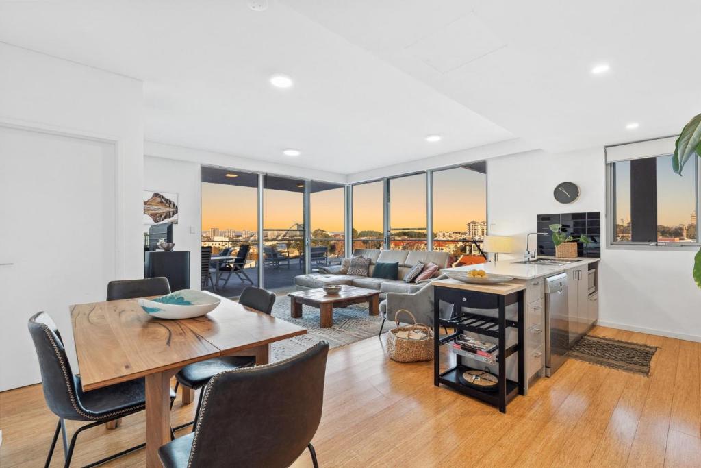 a kitchen and living room with a table and chairs at EAST34/60 - Urban Sanctuary in Perth