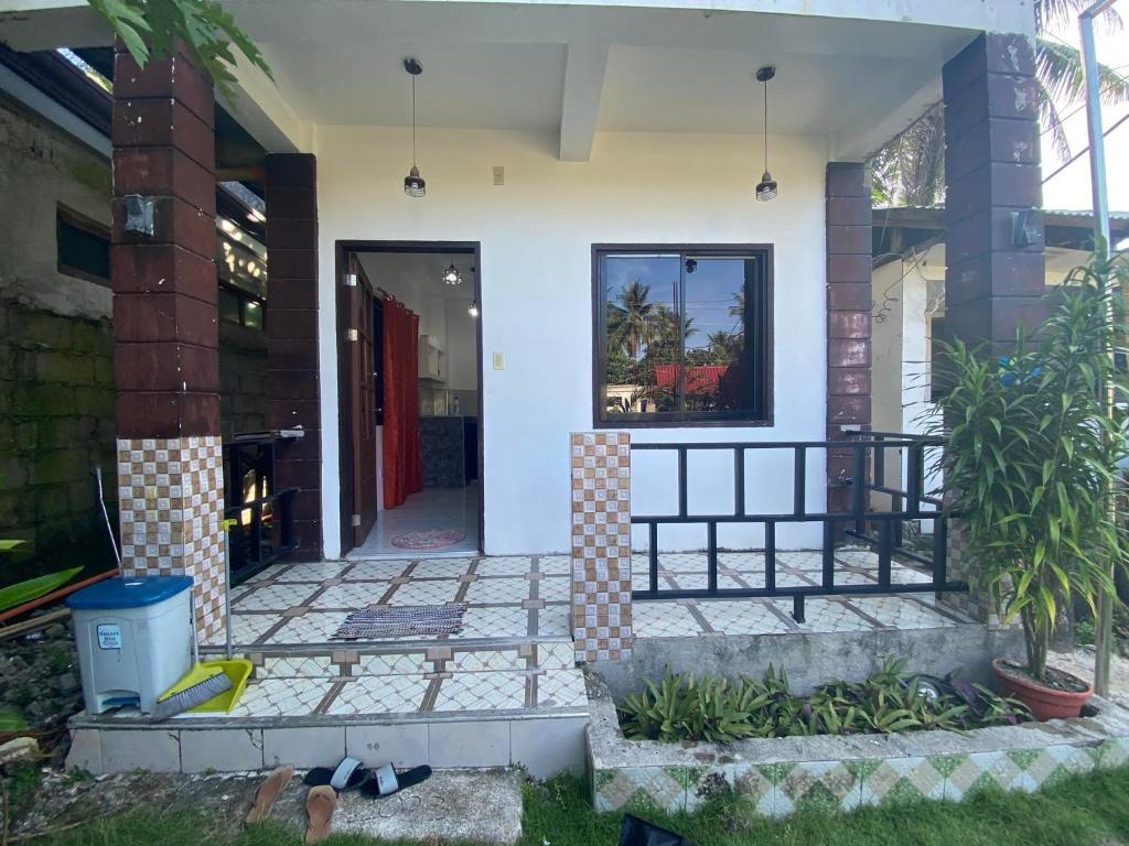 eine Eingangstür eines Hauses mit einer Veranda in der Unterkunft Jmt star's inn in General Luna