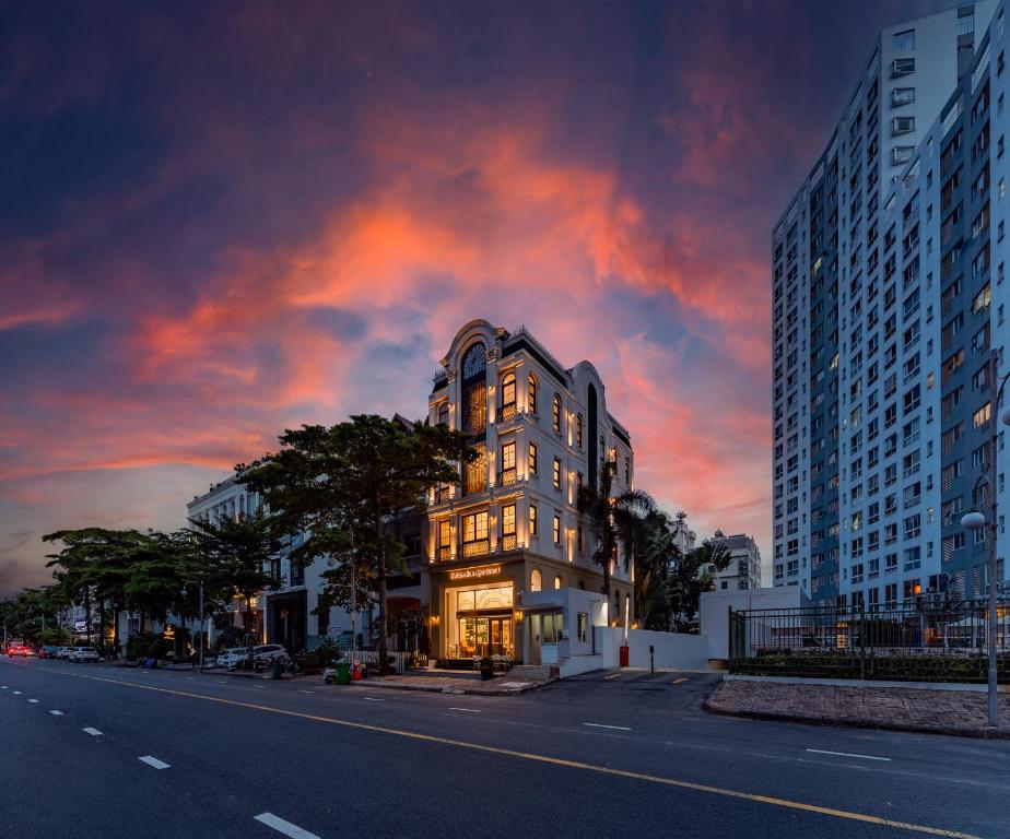 a building on the side of a city street at sunset at Golden Sun Apartment & Hotel in Ho Chi Minh City