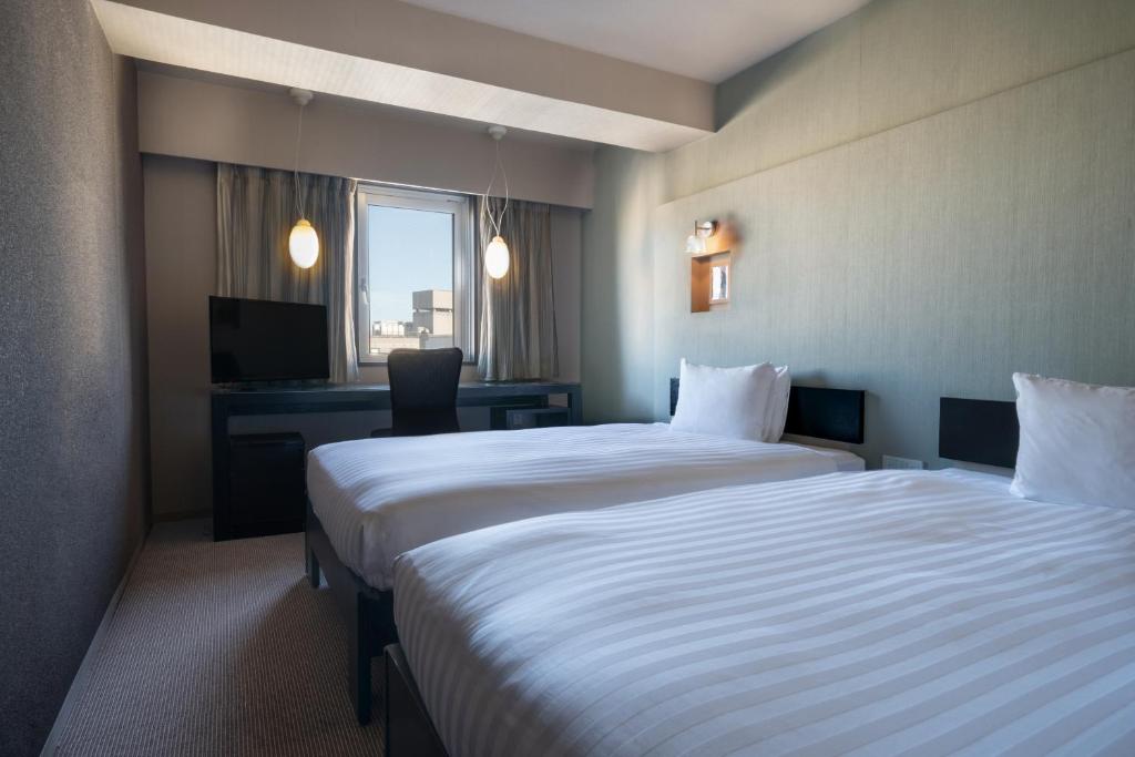 Postel nebo postele na pokoji v ubytování Hotel Vista Atsugi