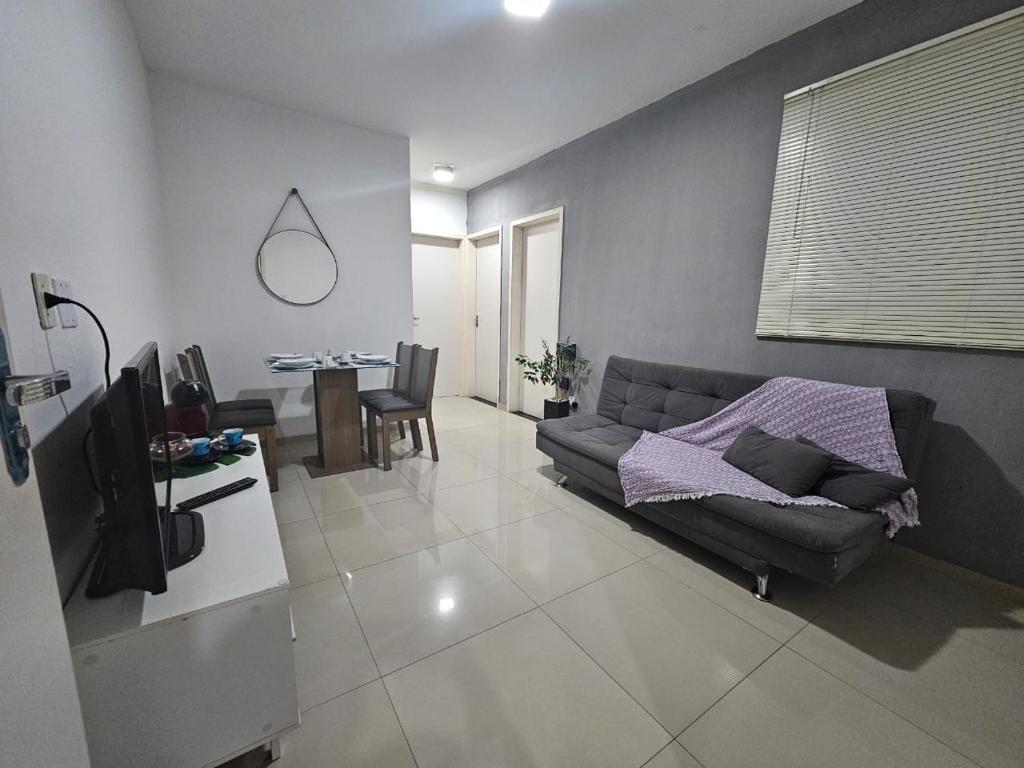 a living room with a couch and a television at Marques Beach House MCZ in Maceió