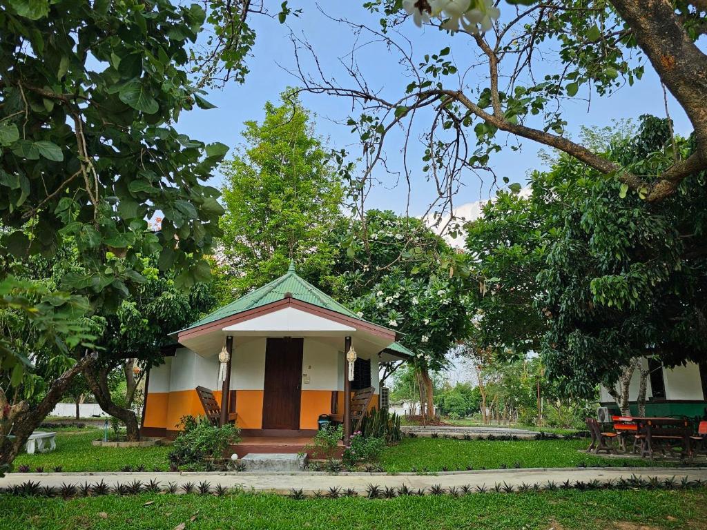 a small house with a porch in a park at Holiday Resort Rimping in Ban Nong Khong