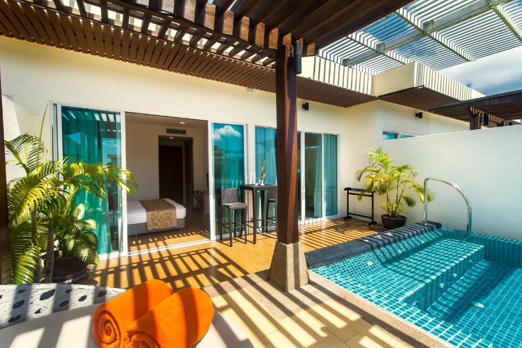a swimming pool on a patio with a house at Krabi Luxury Penthouse in Klong Muang Beach