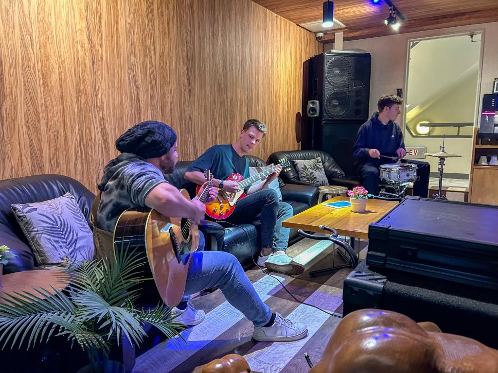 a group of men playing music in a living room at Feel Osaka Yu in Osaka
