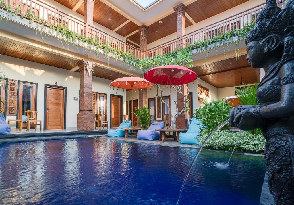 a fountain in the middle of a pool in a house at Raka Rai Homestay in Canggu