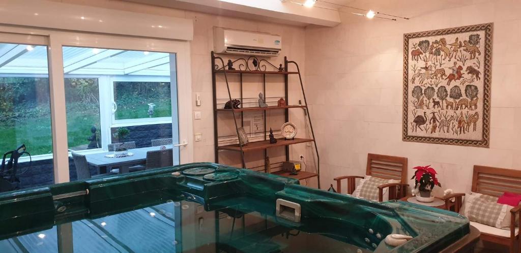 a room with a glass counter top in a room at Le grand jardin de Gaïa et de Rose in Halinghen
