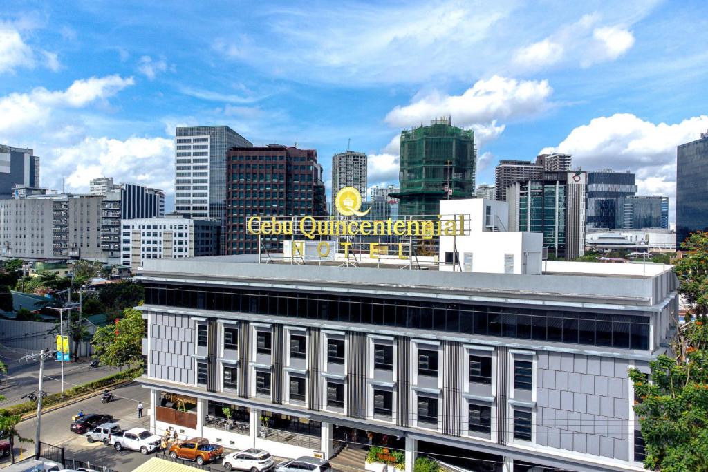 a building with a sign on top of it in a city at Cebu Quincentennial Hotel in Cebu City
