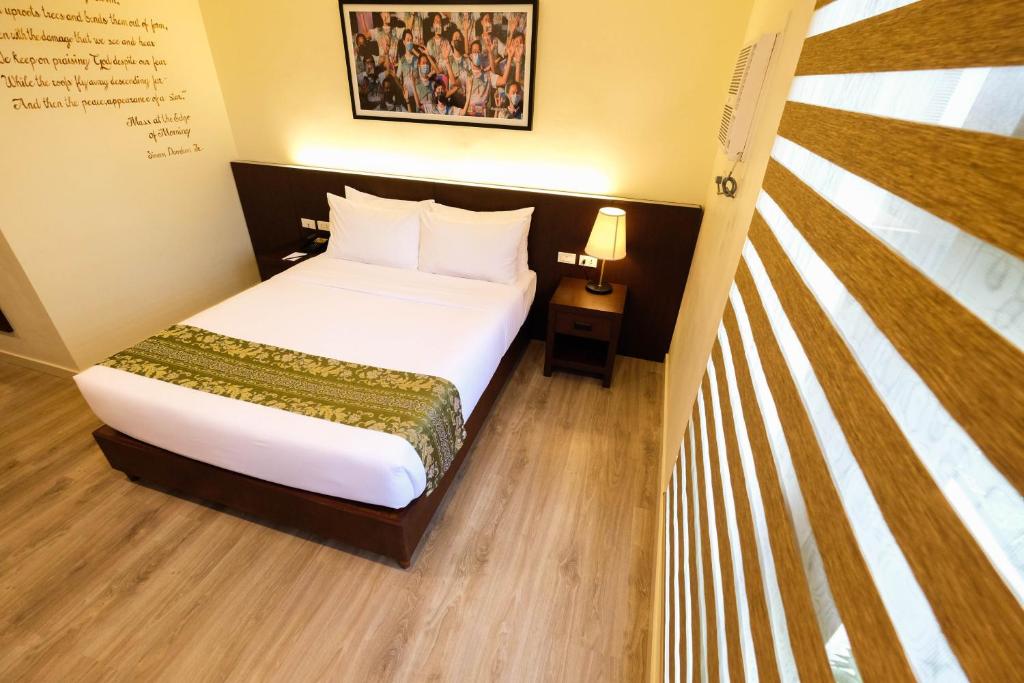Postel nebo postele na pokoji v ubytování Cebu Quincentennial Hotel