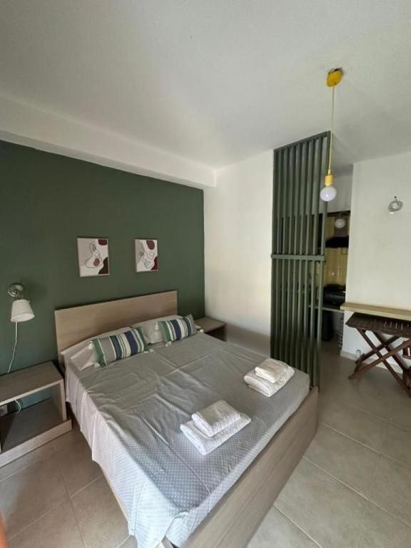 a bedroom with a bed with two pillows and a piano at Central Apart. 4U in Ierapetra