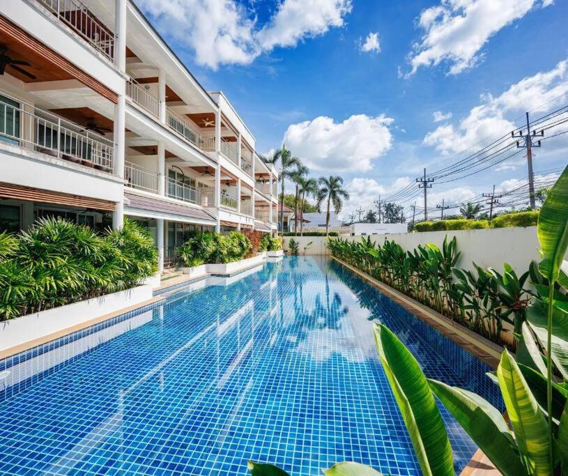a swimming pool in front of a building at Seaview Condo with Large Pool - BAP1 in Phuket Town