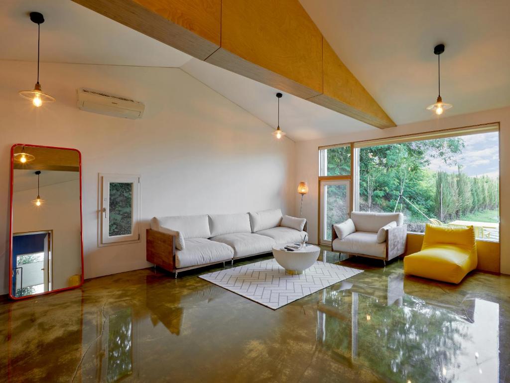 a living room with a couch and a table at Tokkijib Stay in Gyeongsan