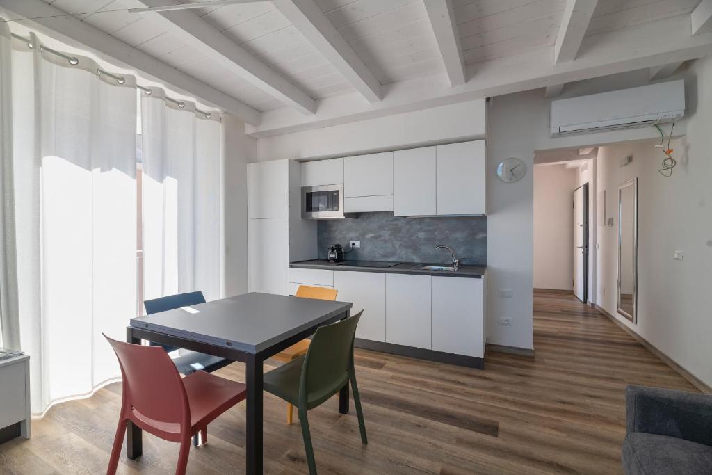 a kitchen and dining room with a table and chairs at VILLA CADIZ APARTMENTS VARAZZE in Varazze