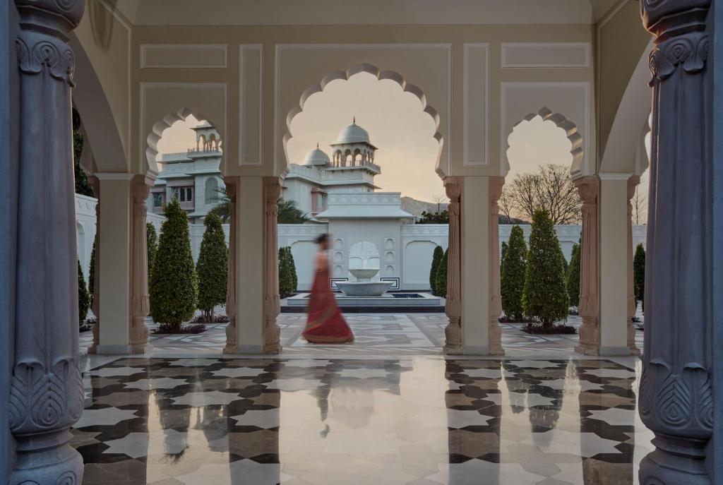 a woman in a red dress in front of a building at Mementos by ITC Hotels Jaipur in Jaipur