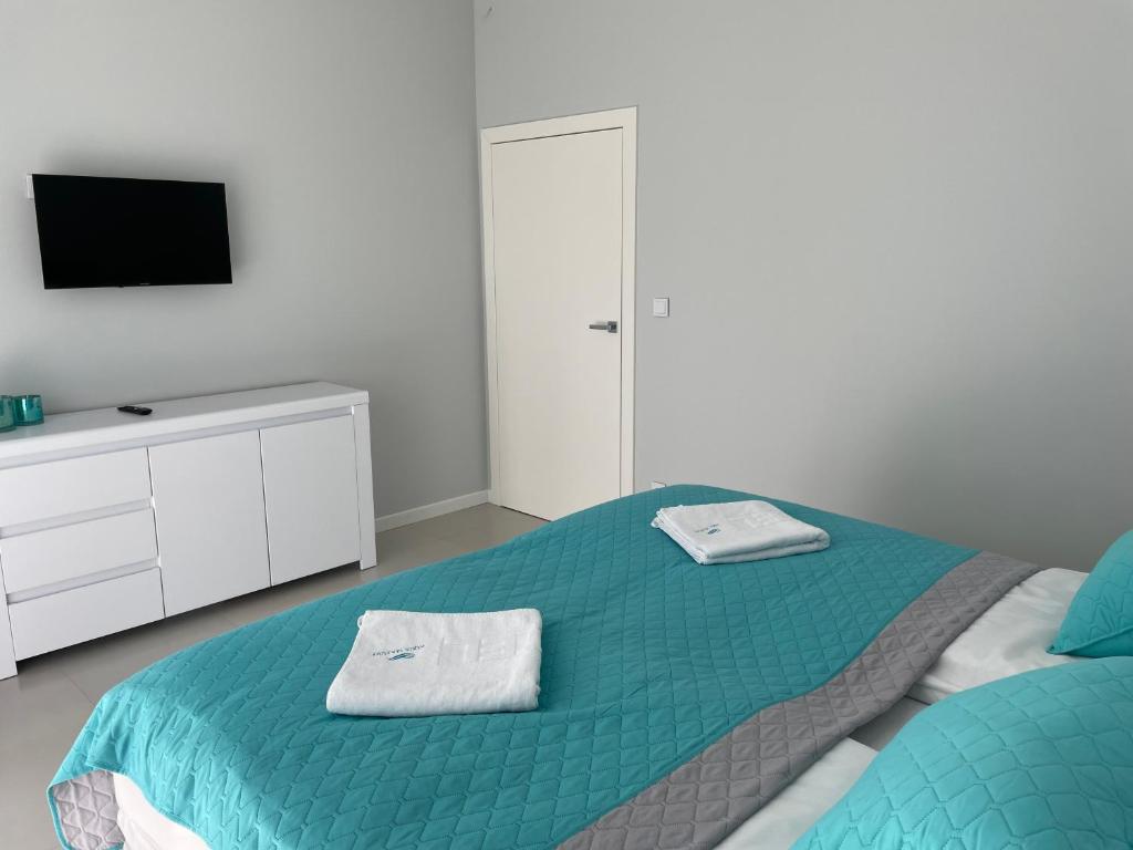 Posteľ alebo postele v izbe v ubytovaní Apartamenty AQUA MAZURY