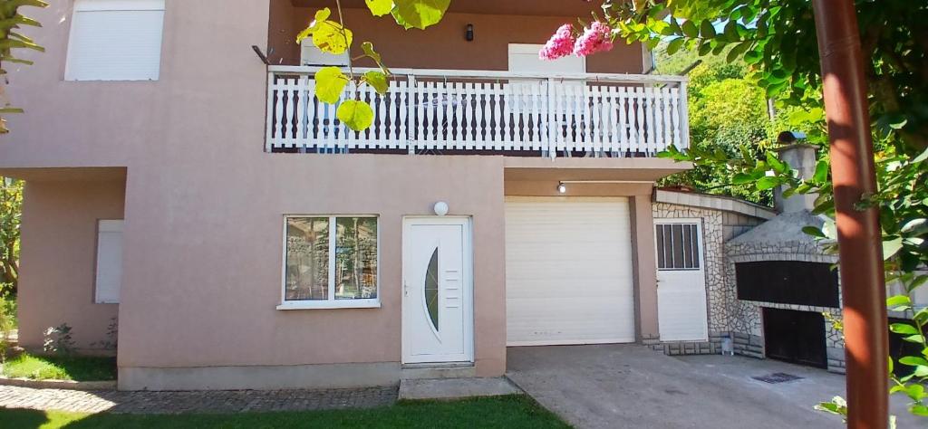 a house with a white door and a balcony at Sara&Sami in Mostar