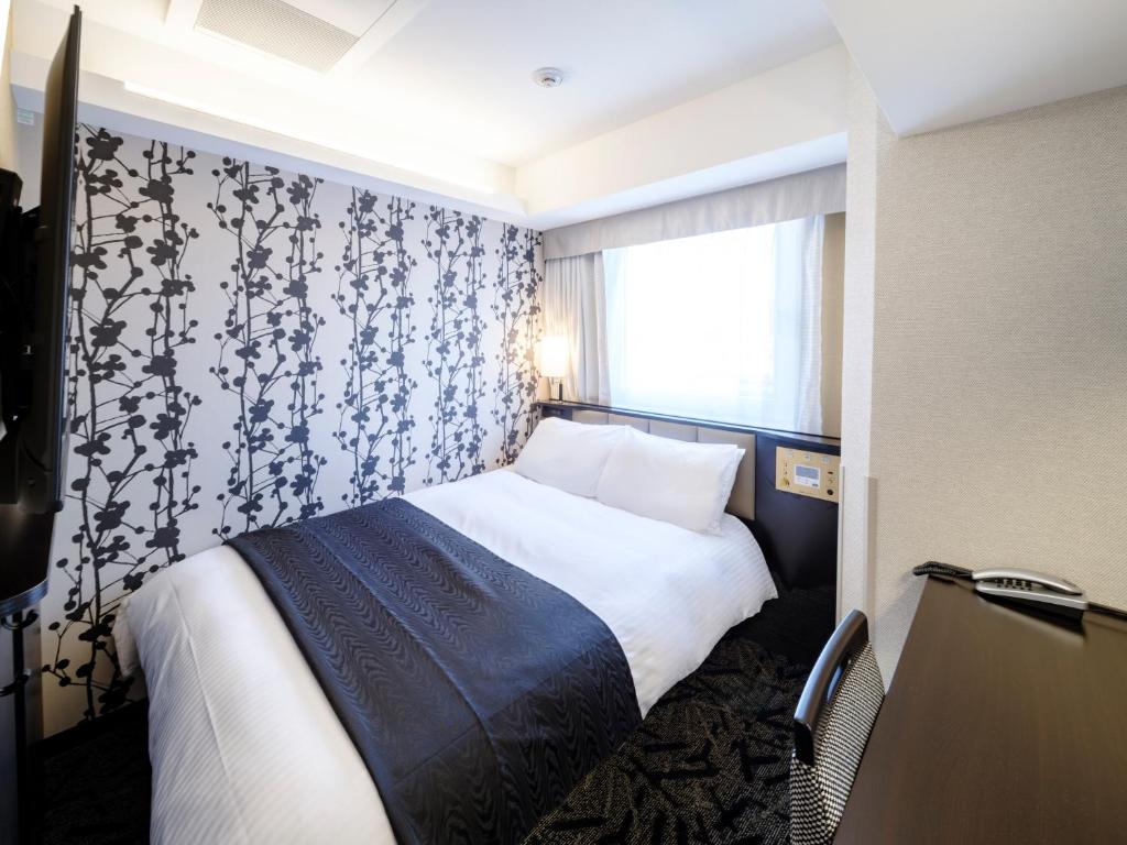 Postel nebo postele na pokoji v ubytování APA Hotel AkihabaraSuehirocho Ekimae -Electric Town-