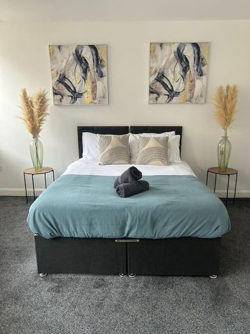 a bedroom with a bed with a teddy bear on it at Spacious Leicester Apt with Free Parking, Sleeps 6 in Leicester