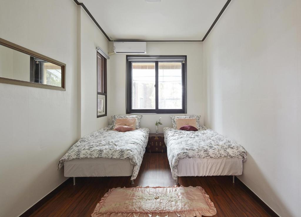 Postel nebo postele na pokoji v ubytování Jiwoljang Guesthouse