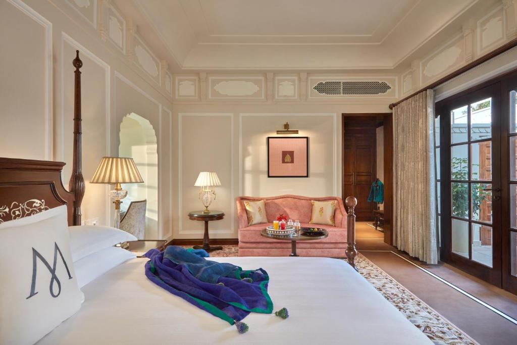 a bedroom with a large bed and a couch at Mementos by ITC Hotels Jaipur in Jaipur