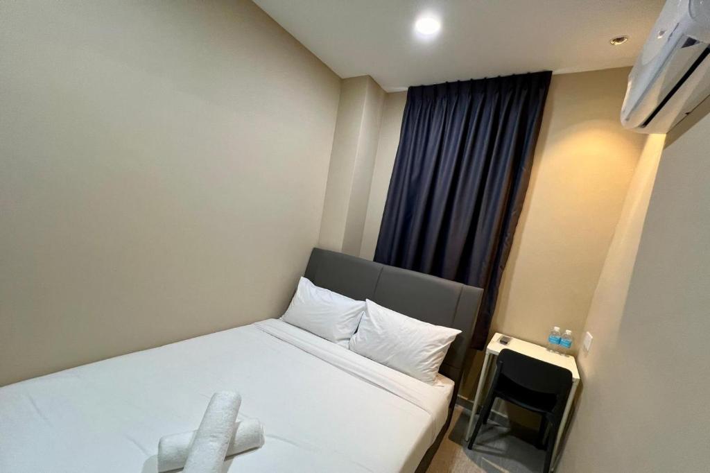 Postel nebo postele na pokoji v ubytování Infinity Hotel Iskandar Puteri