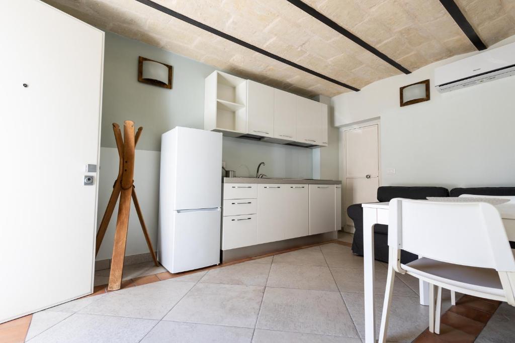 a kitchen with a white refrigerator and a table at A casa di Edo in Matera