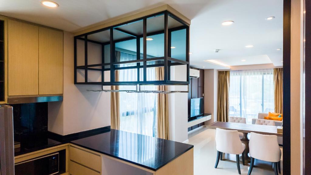 a kitchen with a table and a chandelier at Apartment 2 bedrooms on Surin in Surin Beach
