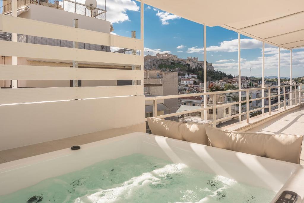 a hot tub on the balcony of a building at Syntagma Spa with Acropolis View in Athens