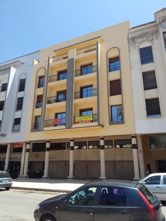 a black car parked in front of a building at Location saisonnière in Settat