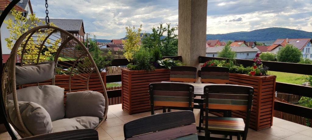 a patio with chairs and a table on a balcony at Pension Panorama in Odorheiu Secuiesc