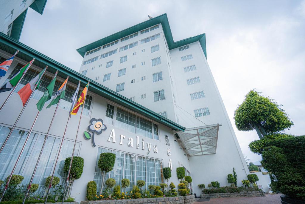 an office building with flags in front of it at Araliya Red - Budget friendly Hotel- Where you find stunning 360 panoramic view of Nuwara Eliya in Nuwara Eliya