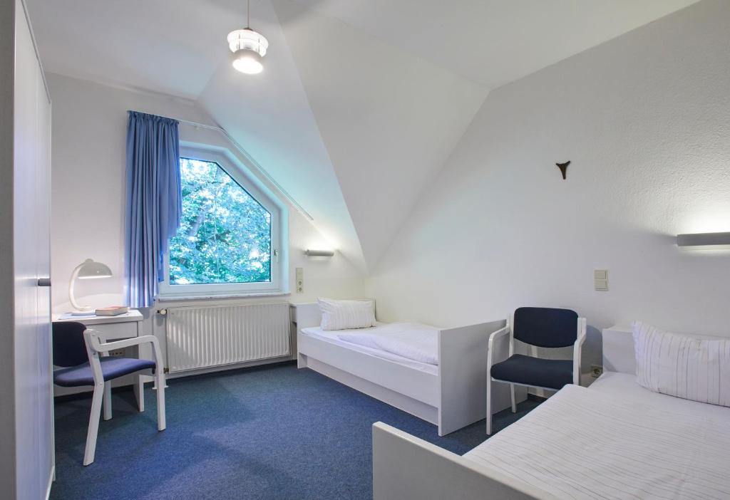 Postel nebo postele na pokoji v ubytování Gästehaus im LWH