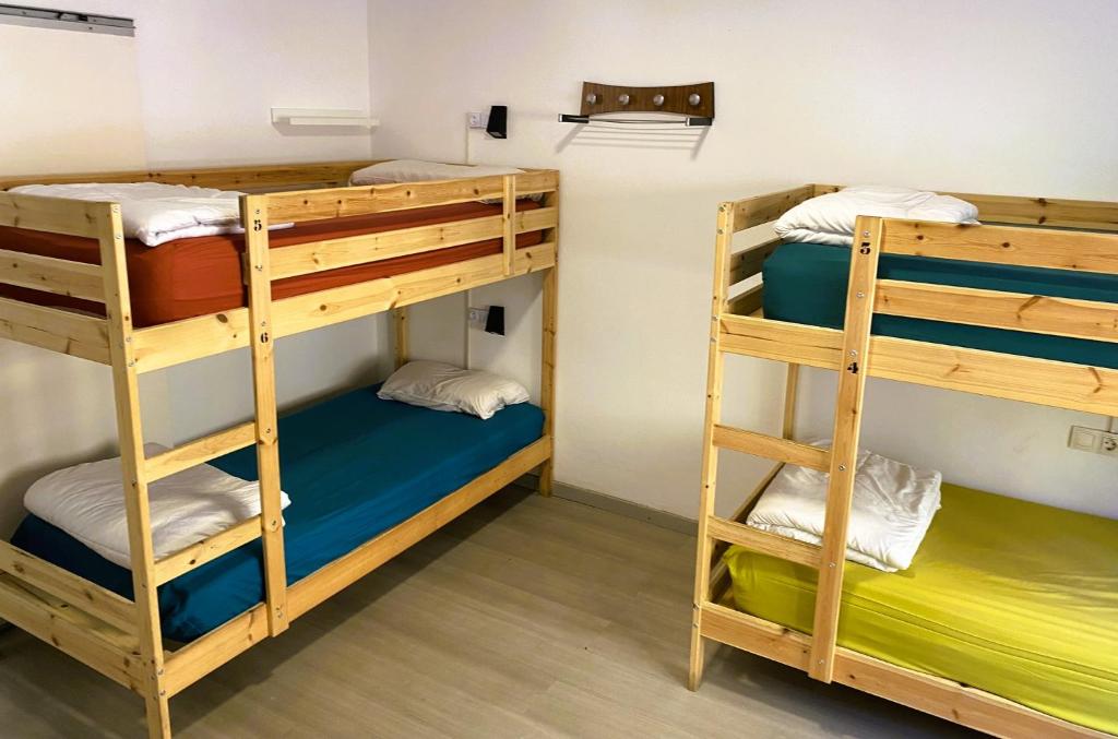 Postel nebo postele na pokoji v ubytování Alberg Els Andes