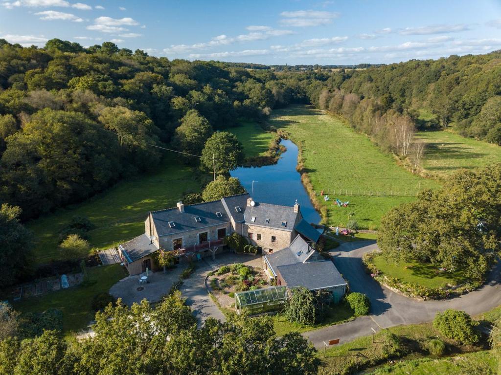 an aerial view of a large house next to a river at Le Moulin des hirondelles in Pluvigner
