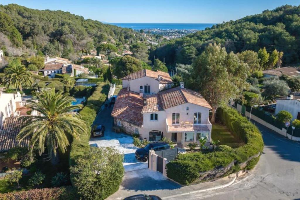 an aerial view of a house with a palm tree at Twin Luxurious Villas 8 BR Pool in Vallauris in Vallauris