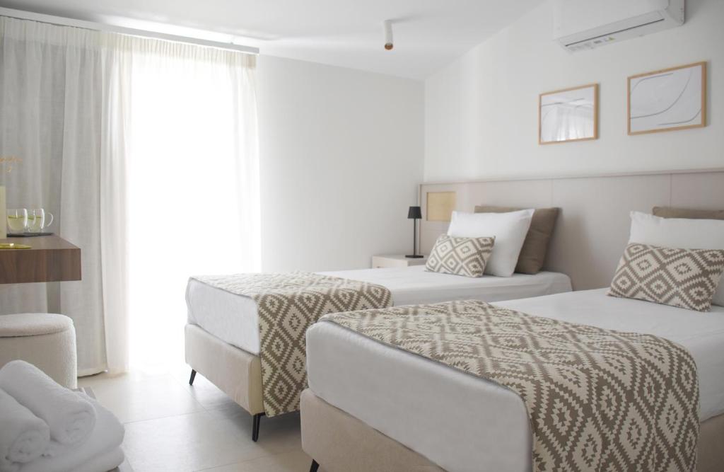 Łóżko lub łóżka w pokoju w obiekcie Evangelia Rooms & Αpartments - B