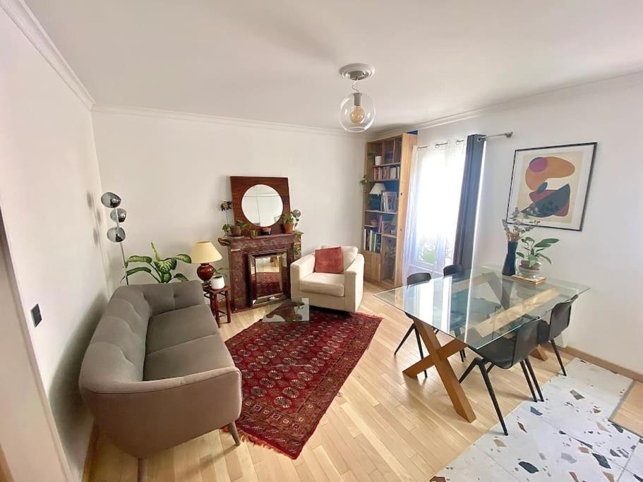 a living room with a couch and a glass table at Mosaic Canal - 2 bedrooms flat, 10mn walk to Paris in Pantin