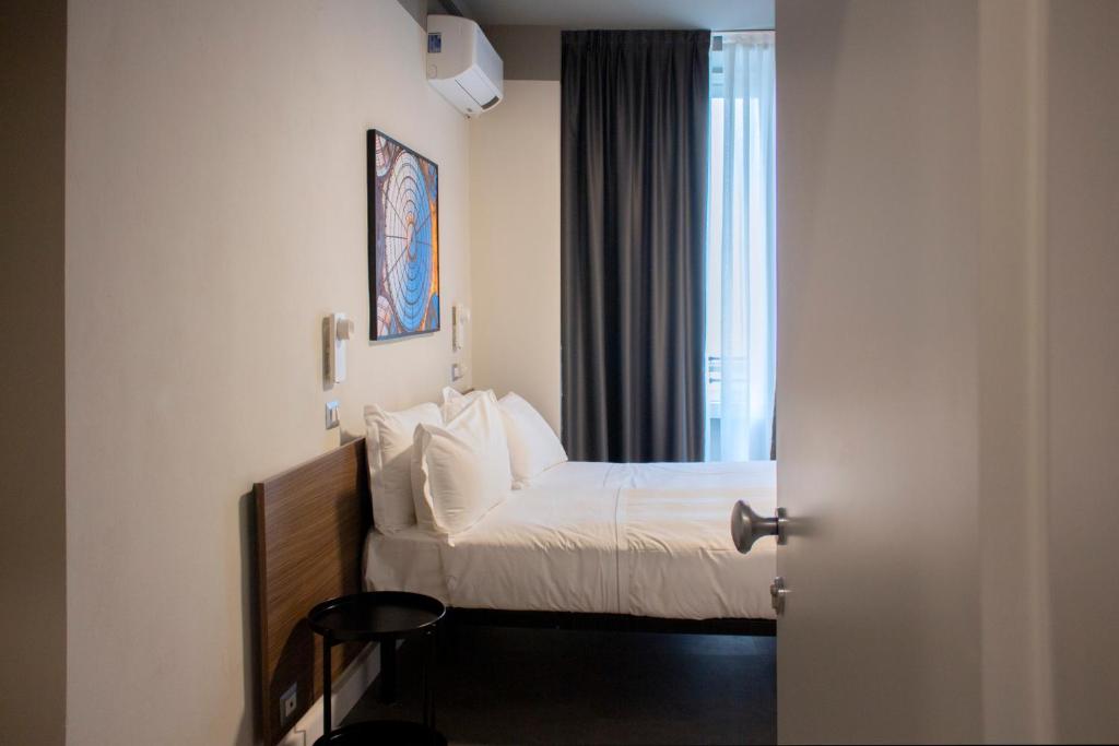 Postel nebo postele na pokoji v ubytování Hotel 22 Marzo