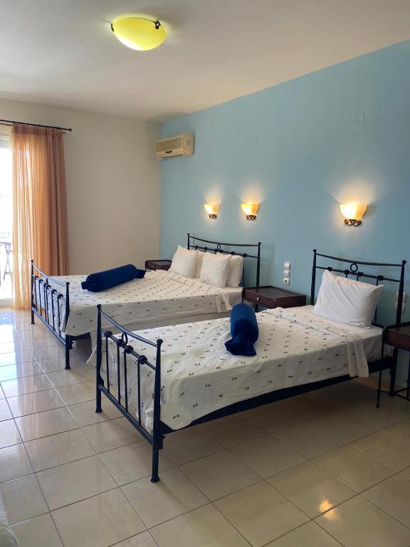 Postel nebo postele na pokoji v ubytování Zeus Paradise Hotel Ammoudia