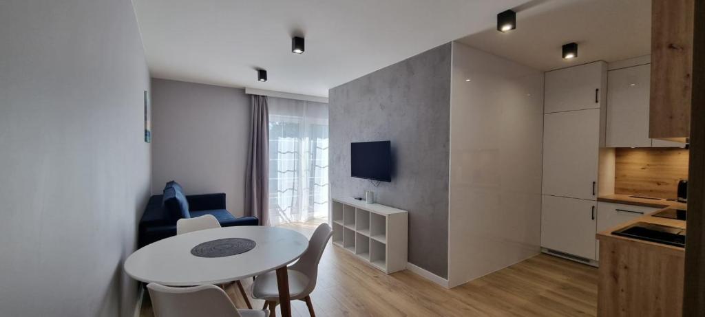 a kitchen and a table and chairs in a room at Apartament nad Sapiną 2 in Kruklanki