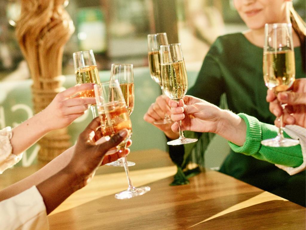 a group of people holding up wine glasses at Santa's Hotel Santa Claus in Rovaniemi